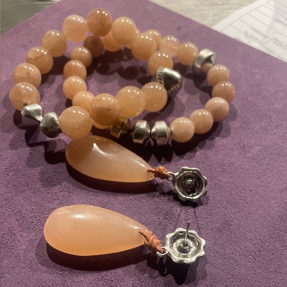 Chicos stretch two bracelets with matching earrings.